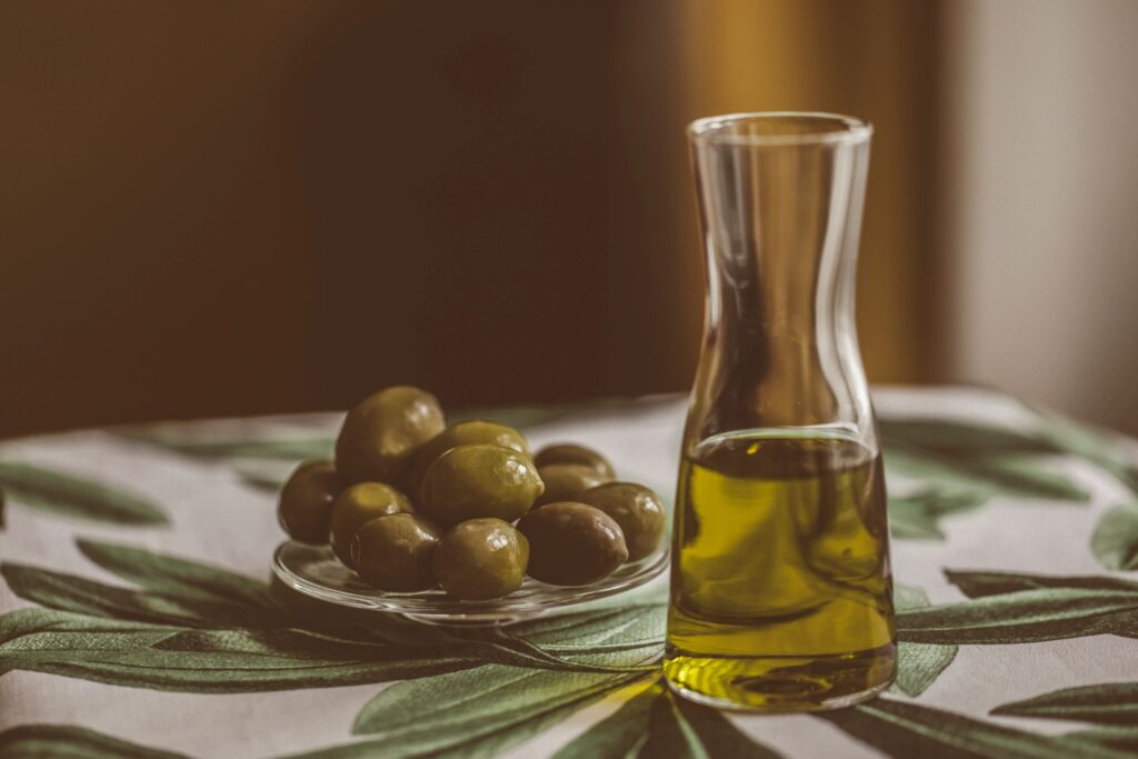 Spanish Manzanilla olives jar with a small bowl of olives nearby
