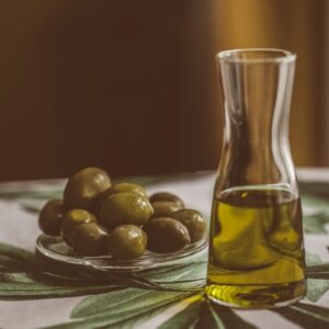 Spanish Manzanilla olives jar with a small bowl of olives nearby