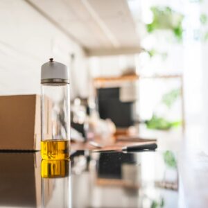 Extra virgin olive oil bottle on a clean, bright kitchen counter